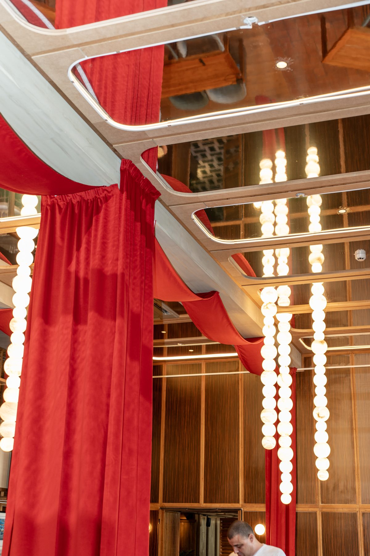 Stars of Monaco — alabaster bead columns and crimson curtain