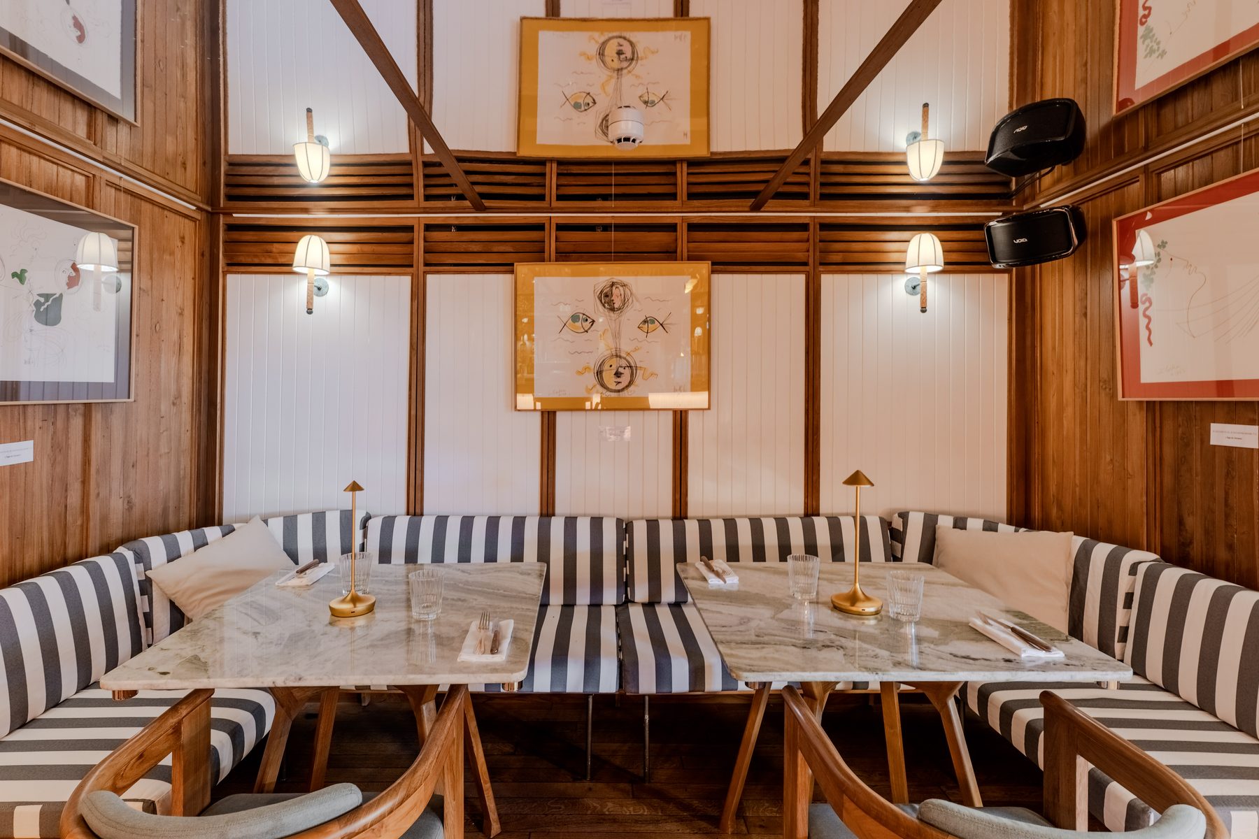 Stars of Monaco — wood-panelled booth with framed photographs